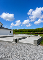 Finished concrete pad with steps beside a garage